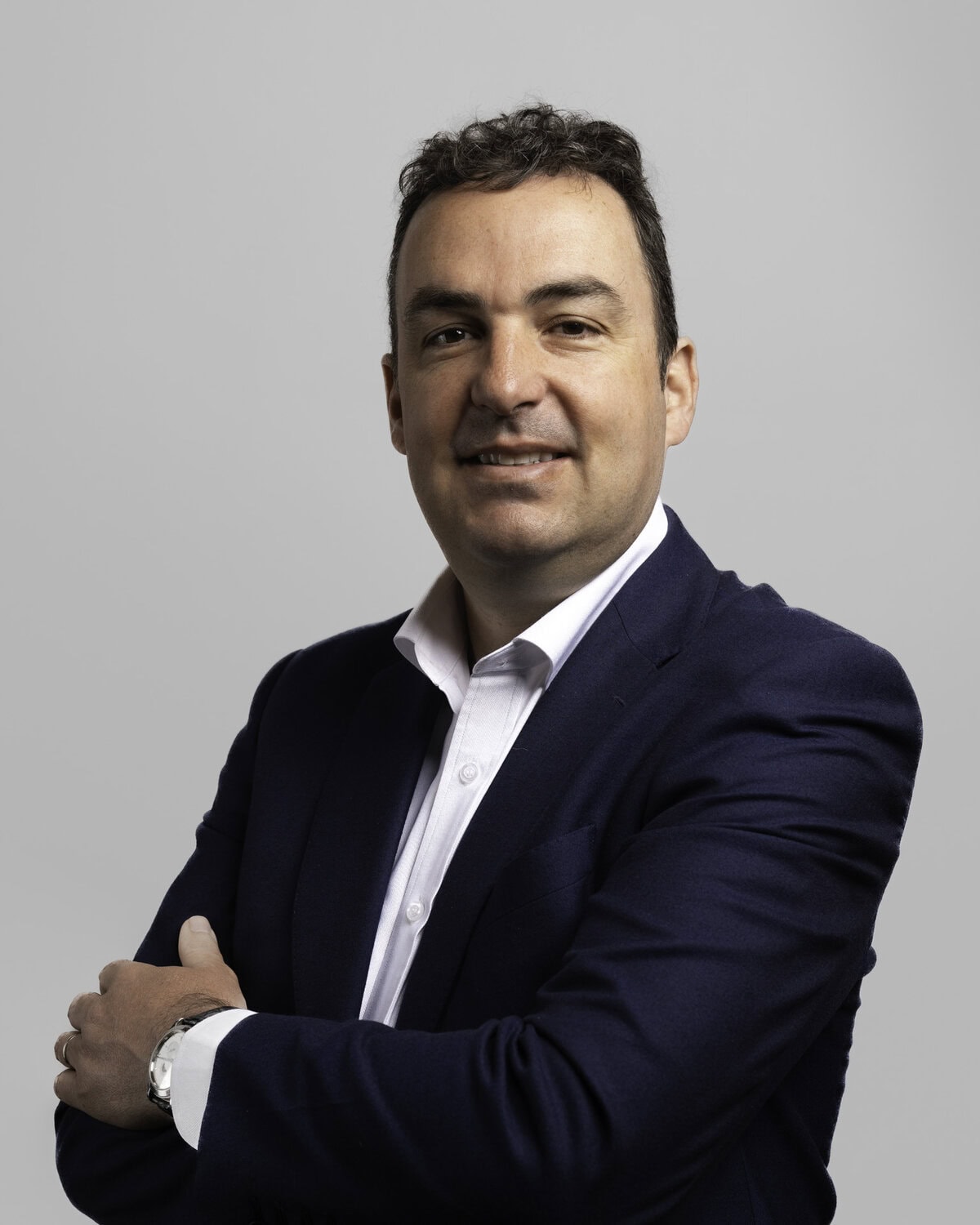 Corporate headshot on a classic grey backdrop