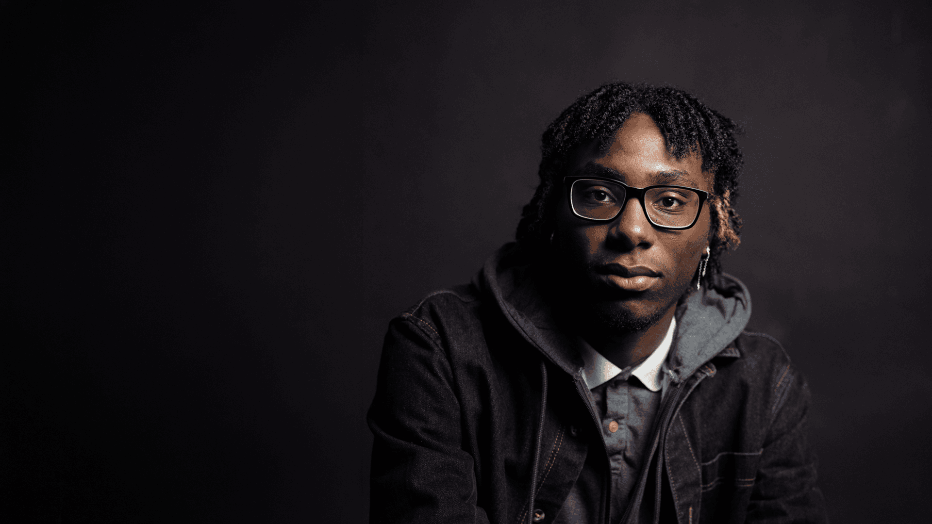 Polished corporate headshot of a young professional photographed in the City of London