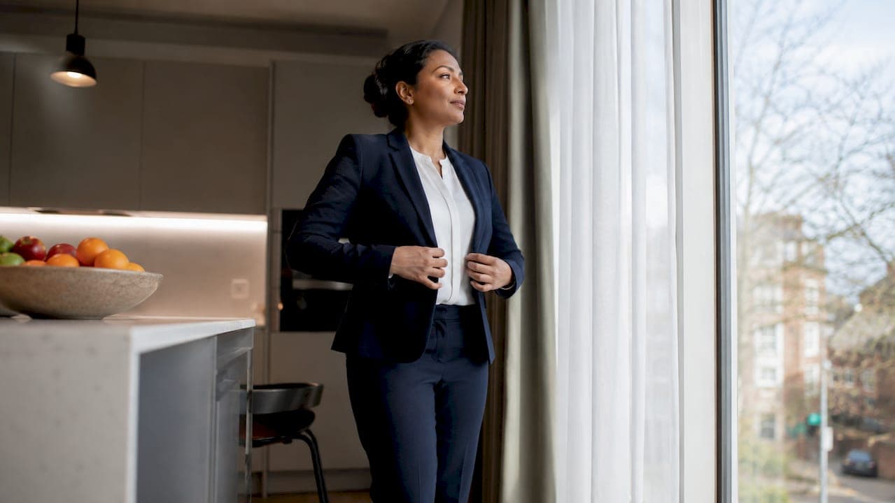 Professional woman adjusting blazer before headshot